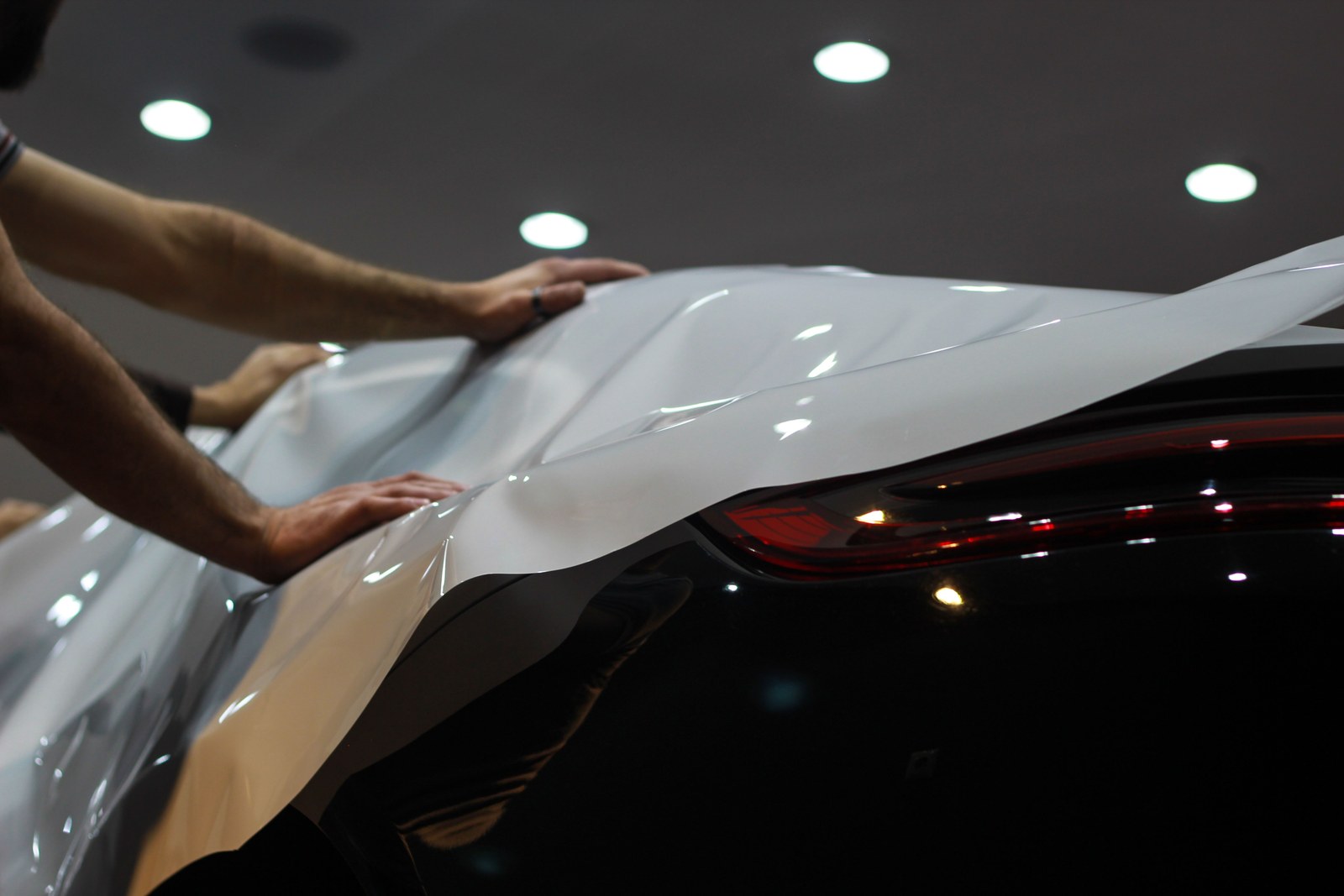 Vinyl car wrap film being applied to a vehicle