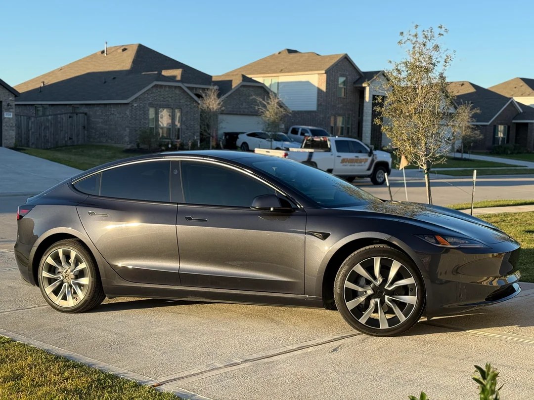 Car with dark window tint parked on a residential street